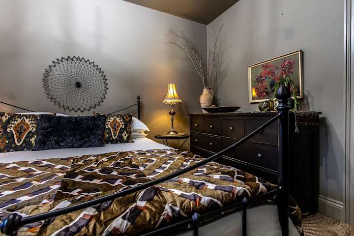 Bedroom with a comfortable bed and stylish wall decor.