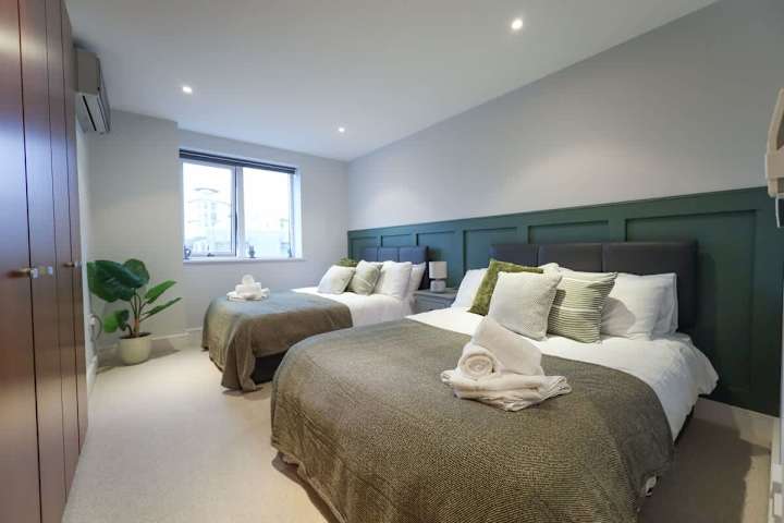 A bedroom with 2 comfortable bed and extra towels and linens provided.