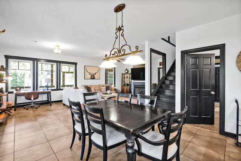 Dining room, stairway to loft, living room and desk area