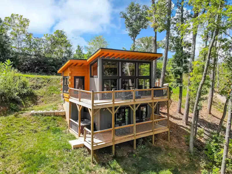 Tranquil Treat cabin among trees with decks on two levels