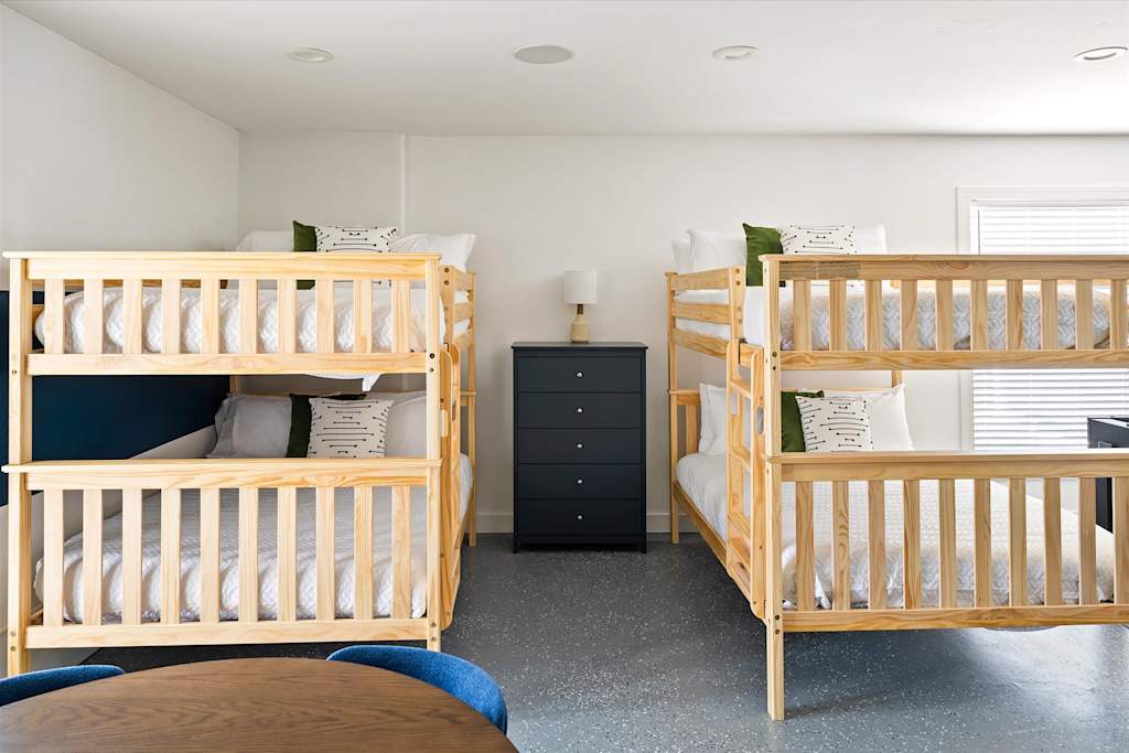 The Scottsdale Social — bedroom featuring two wooden bunk beds and a black dresser between them