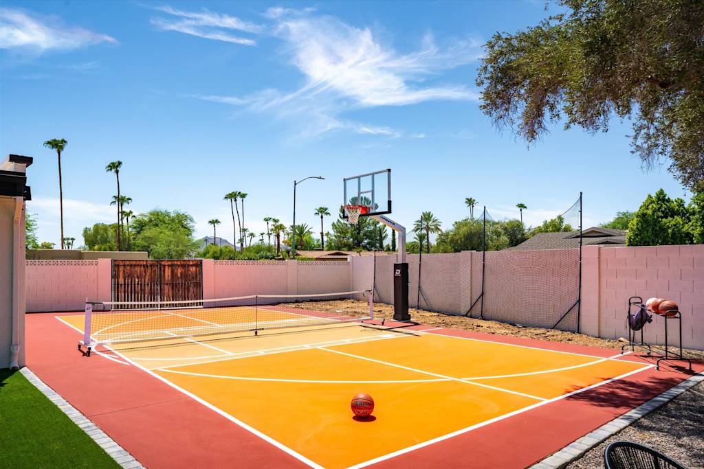 The Sunkiss — outdoor sports court set up for pickleball and basketball in an enclosed backyard
