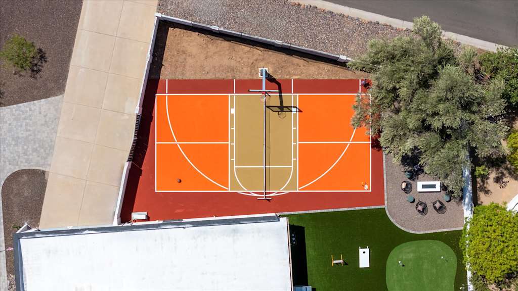 The Sunkiss — aerial top-down view of an outdoor sports court with basketball hoop and net
