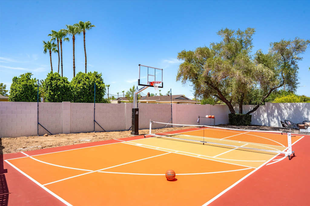 The Sunkiss — outdoor sports court setup for pickleball and basketball with palm trees in the background