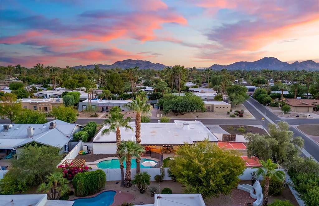 The Sunkiss — aerial view of residential neighborhood and mountain backdrop at sunset