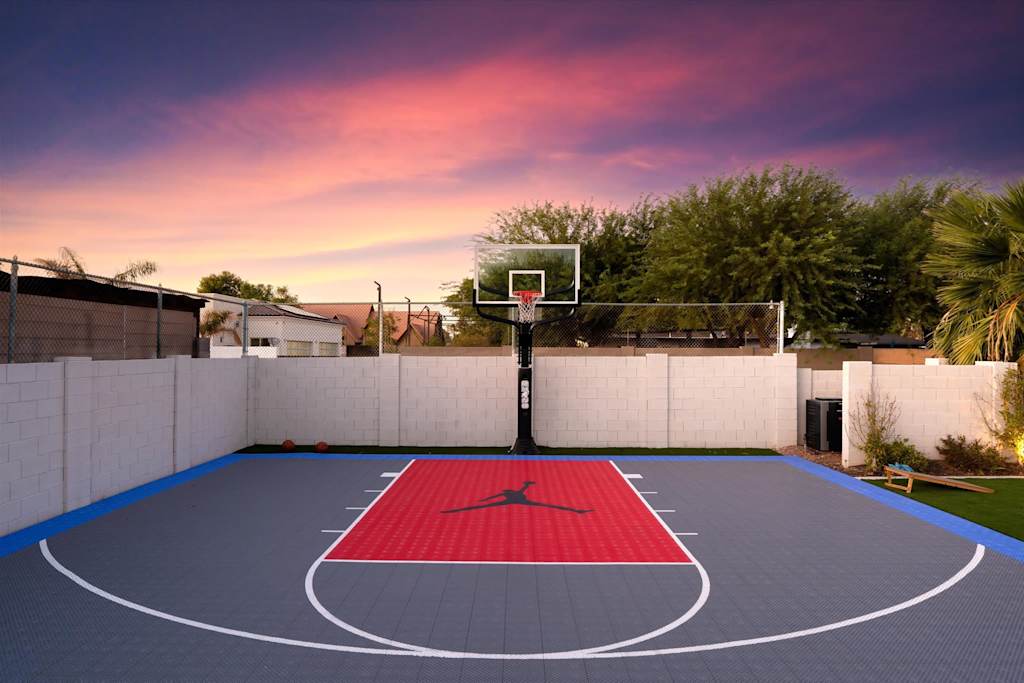 The Scottsdale Social — outdoor basketball half court with a hoop and colored surface against a sunset sky