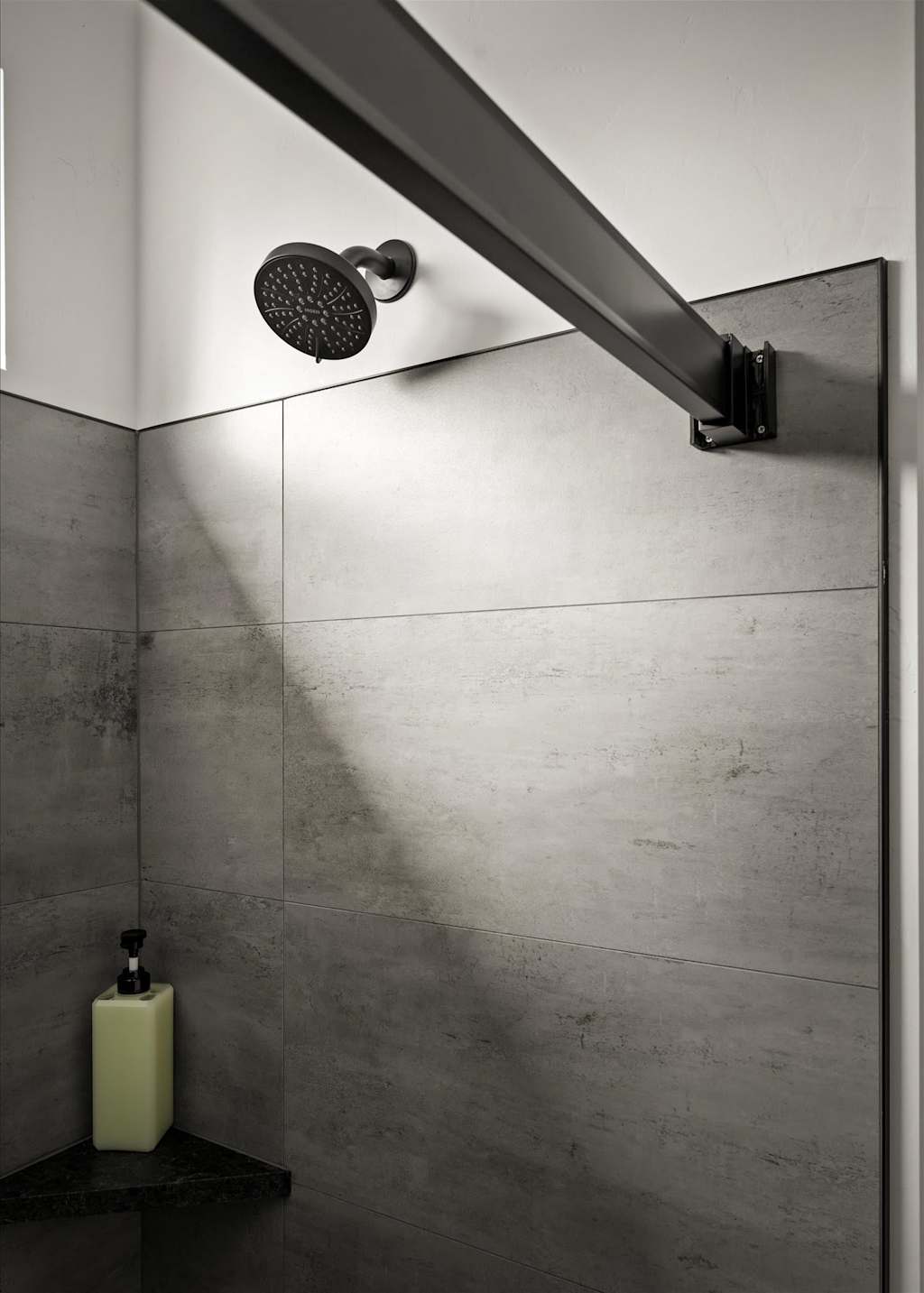 The Evergreen — tiled shower stall with a black showerhead and soap bottle on a corner shelf