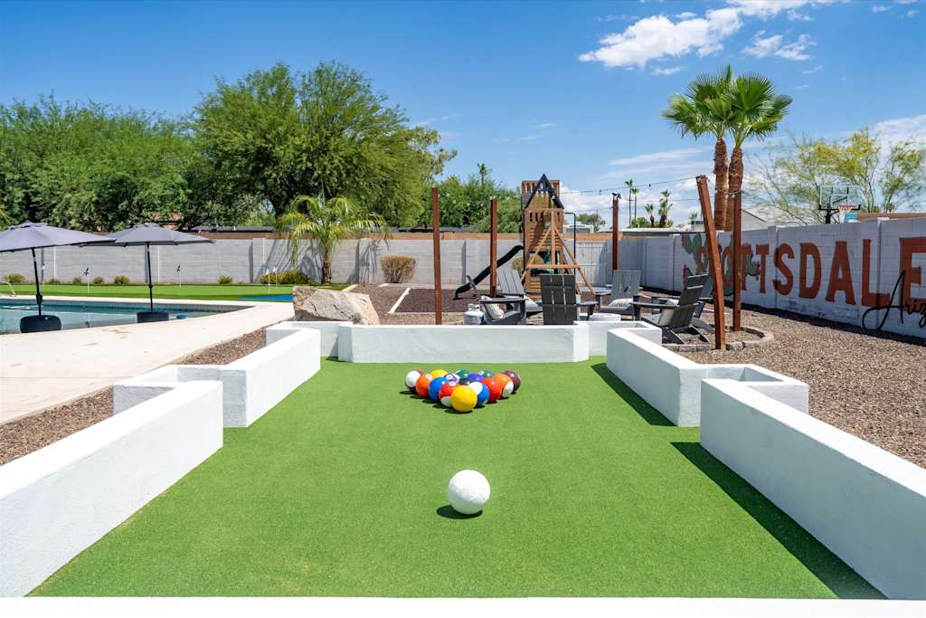 The Scottsdale Social — outdoor footpool setup with colorful numbered balls on green turf in a backyard