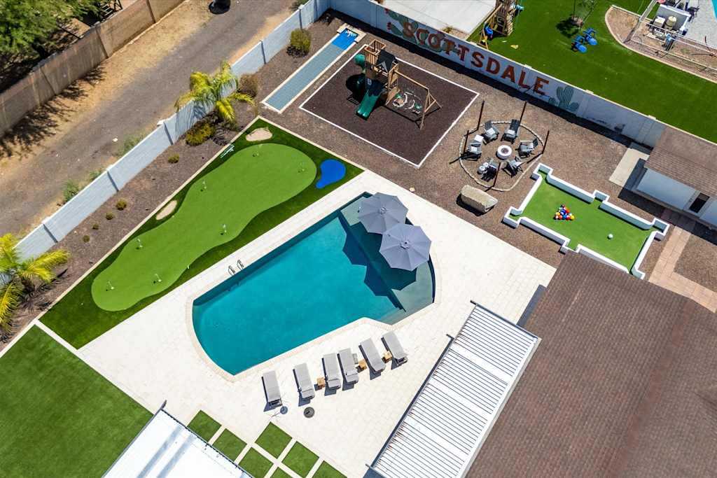 The Scottsdale Social — bird's-eye view of backyard featuring a swimming pool, putting green, patio, and play area