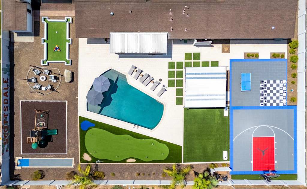 The Scottsdale Social — aerial overhead view of backyard with swimming pool, basketball court, putting green, and outdoor games
