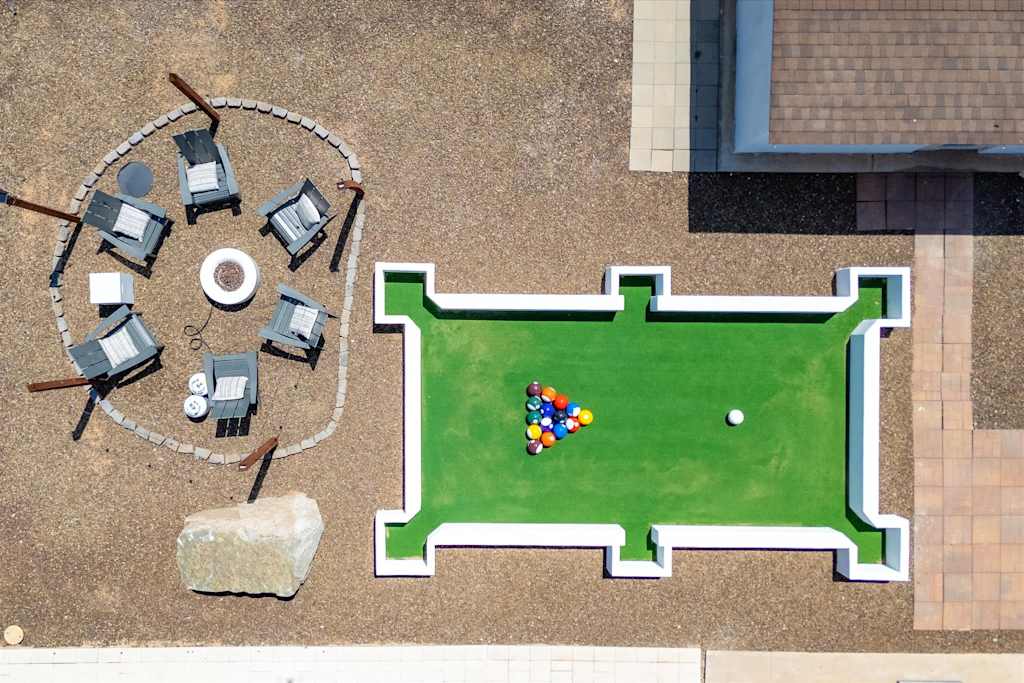 The Scottsdale Social — top-down view of outdoor giant footpool lawn game next to a circular fire pit area