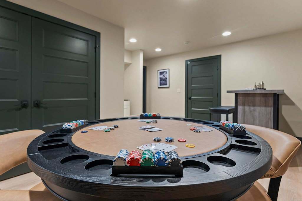 The Tamarack — round poker table set with playing cards and stacks of poker chips