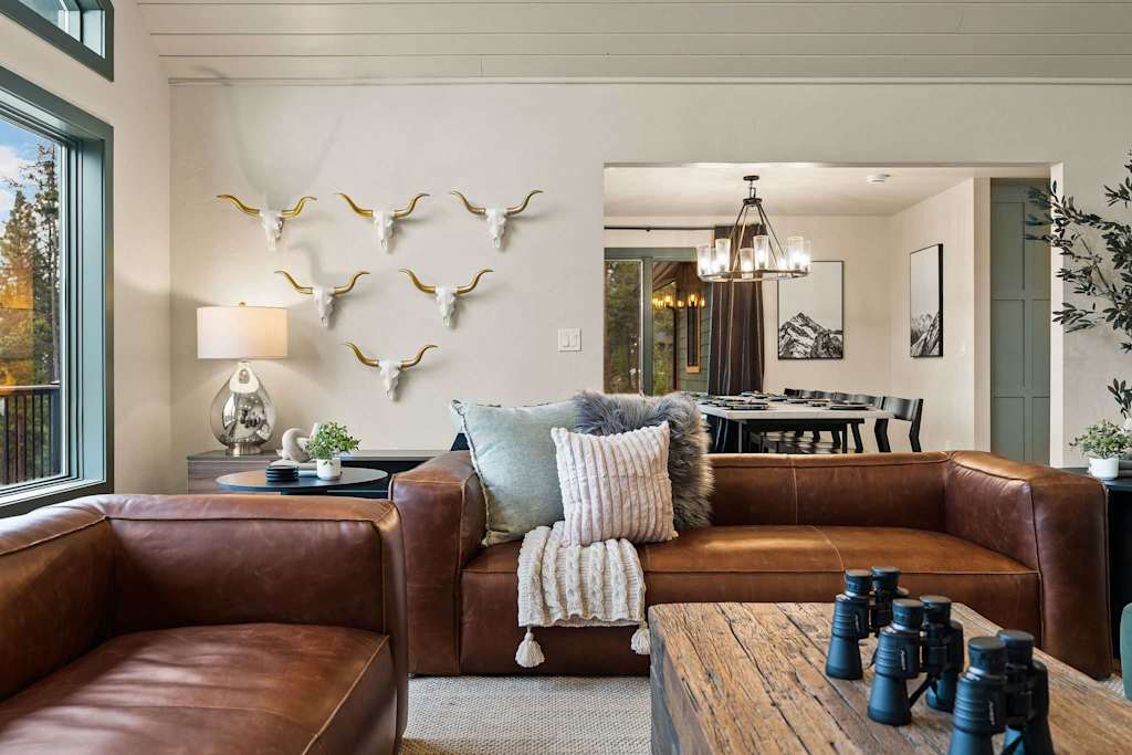 The Tamarack — brown leather sofa in a living room with decorative animal skulls mounted on the wall