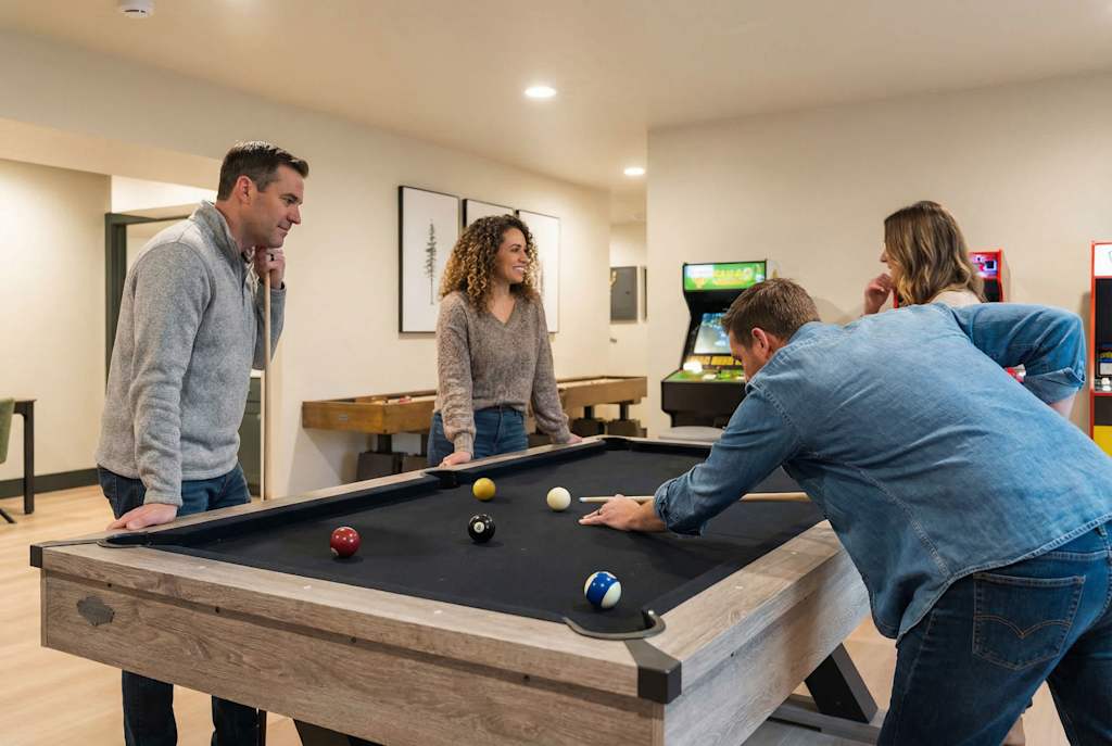 The Tamarack — friends gathered around a pool table playing a game of billiards in a game room