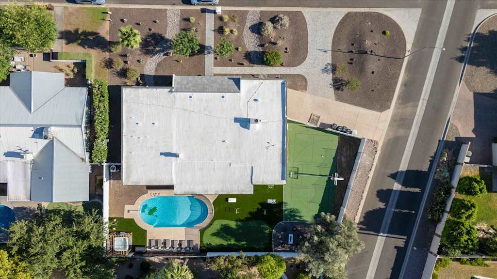 The Sunkiss — top-down aerial view of property showing the house, swimming pool, sports court, and yard