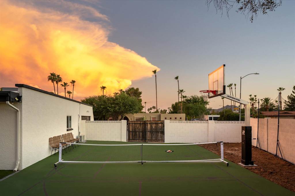 The Sunkiss — outdoor pickleball court and basketball hoop in a residential backyard at sunset