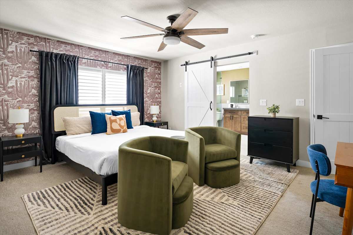 Bedroom with upholstered bed and green lounge chairs — The Scottsdale Social, Scottsdale, Arizona
