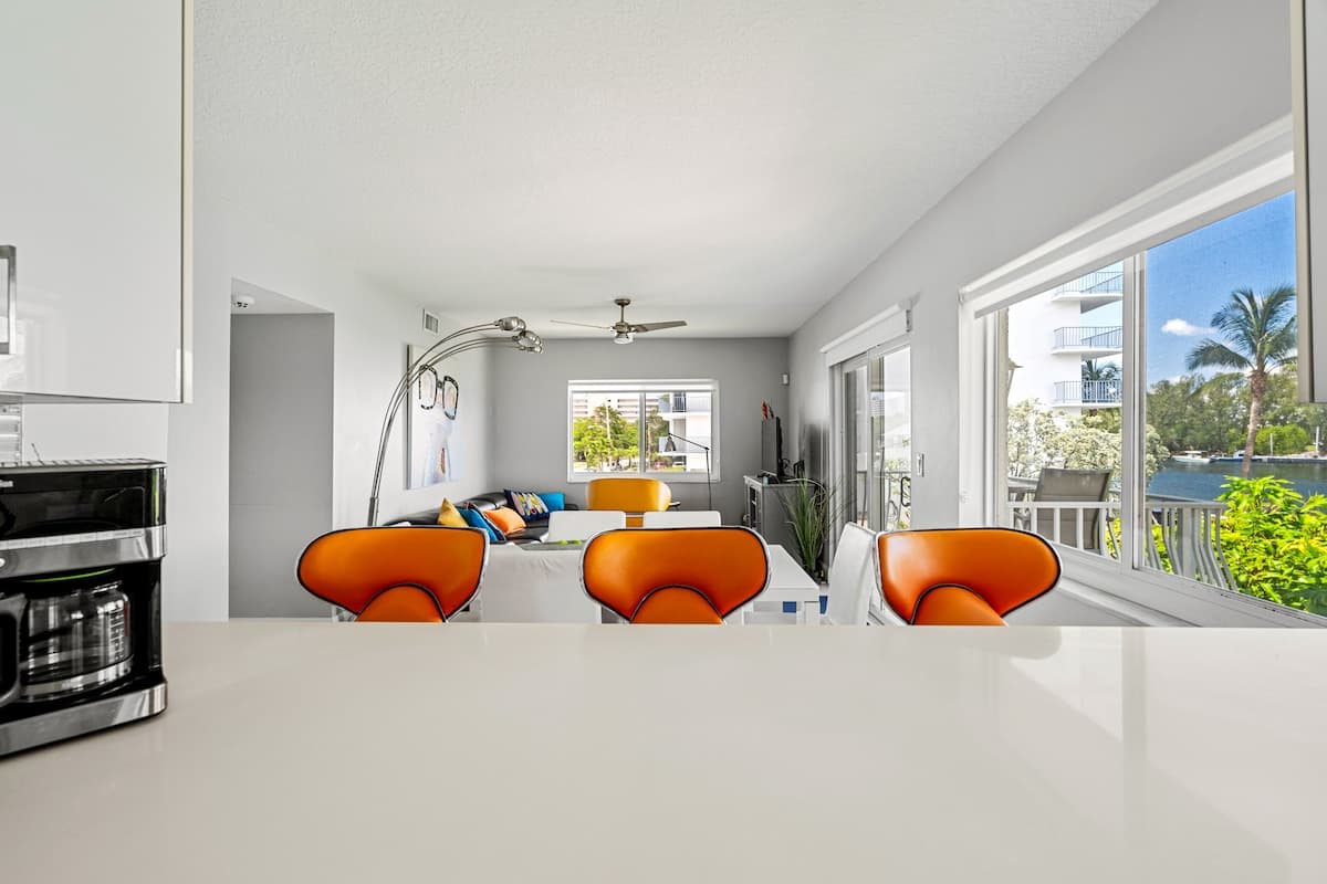 Pompano Condo: The kitchen counter looks out to the dining table and living room