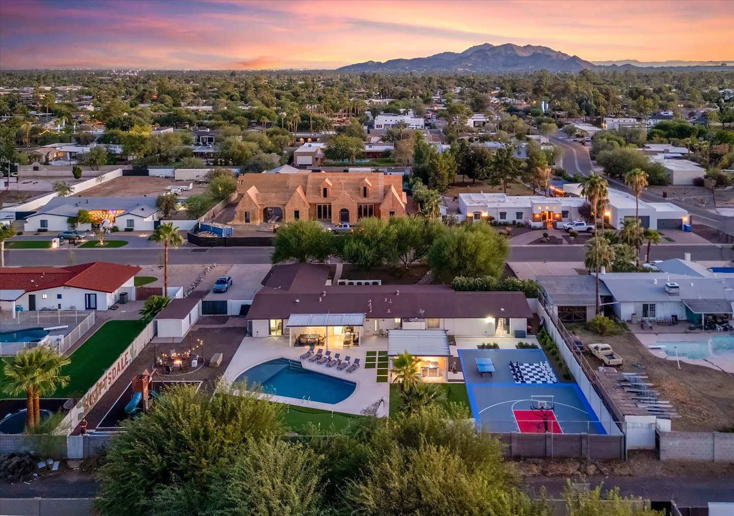 Aerial evening view of the home and surrounding desert neighborhood