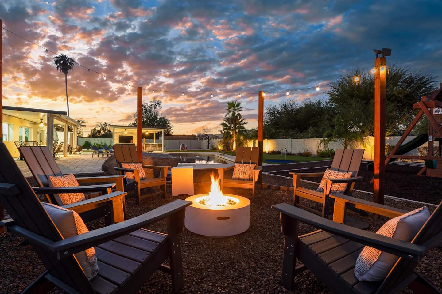 Covered patio seating and fire feature at sunset