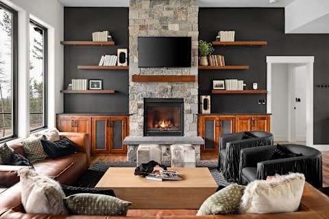 Great room with stone fireplace, built-in shelves and leather seating