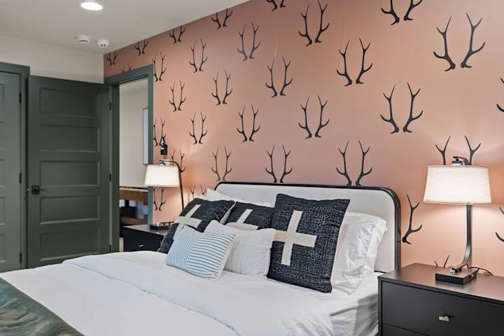 Bedroom with antler-pattern wallpaper