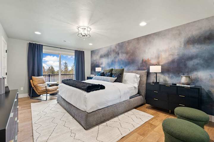 King bedroom with mountain mural and seating area