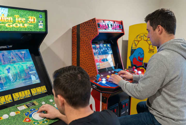 Guests playing arcade games in the game room