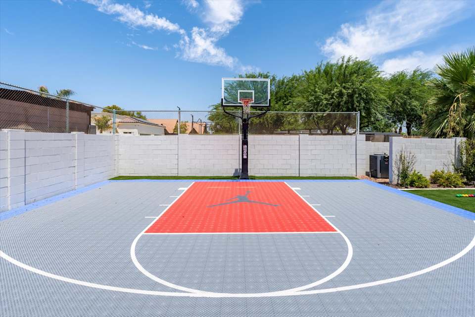 Blue and red basketball half court in daylight