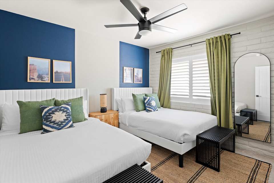 Bedroom with navy accent wall and upholstered bed