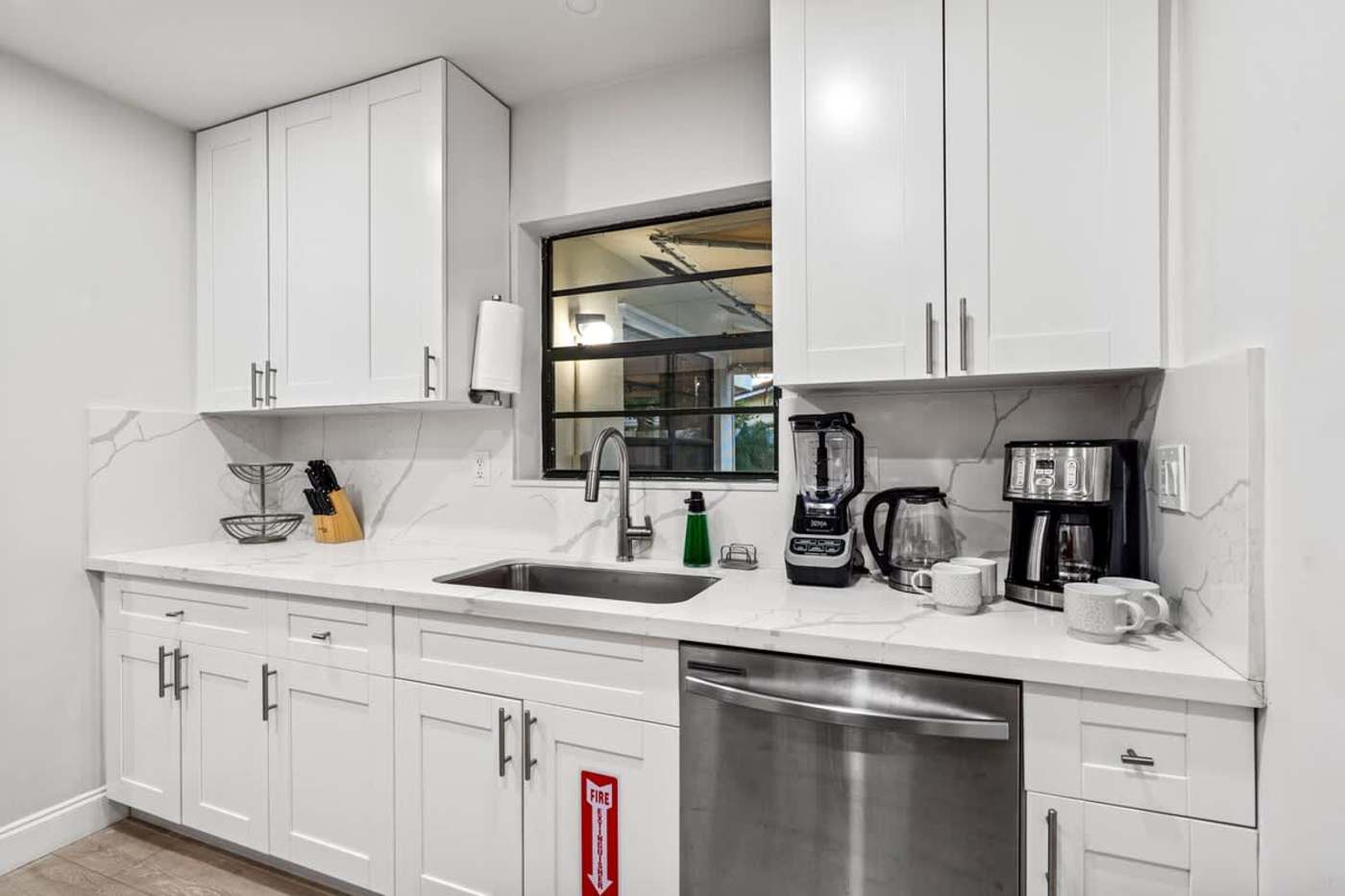 Gardens By The Sea: Kitchen counter with sink, dishwasher, kettle and coffee maker