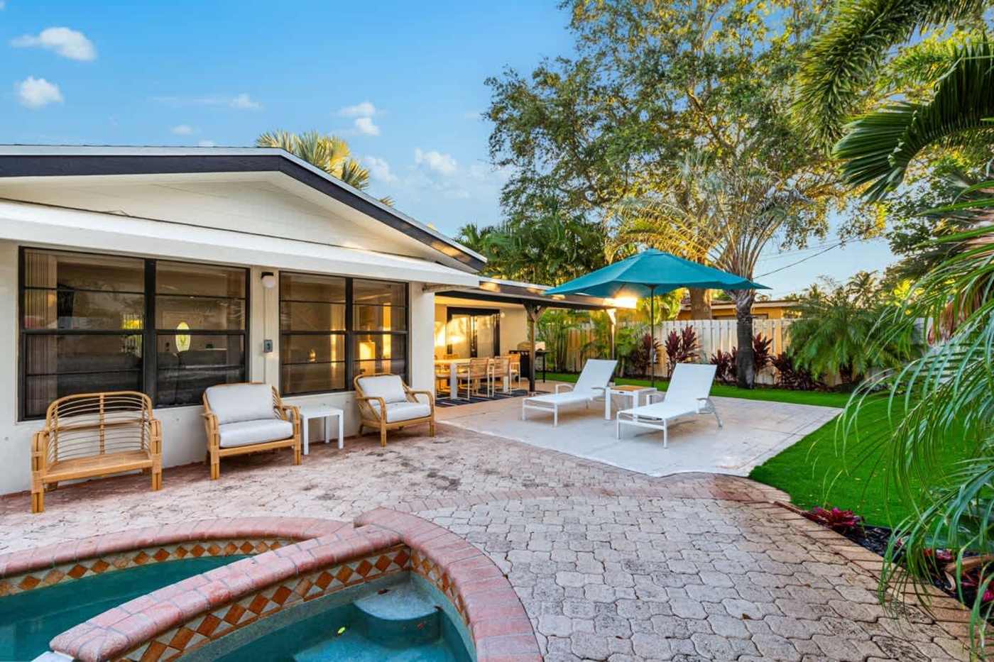 Gardens By The Sea: Pool, spa and lawn, with the covered patio and loungers