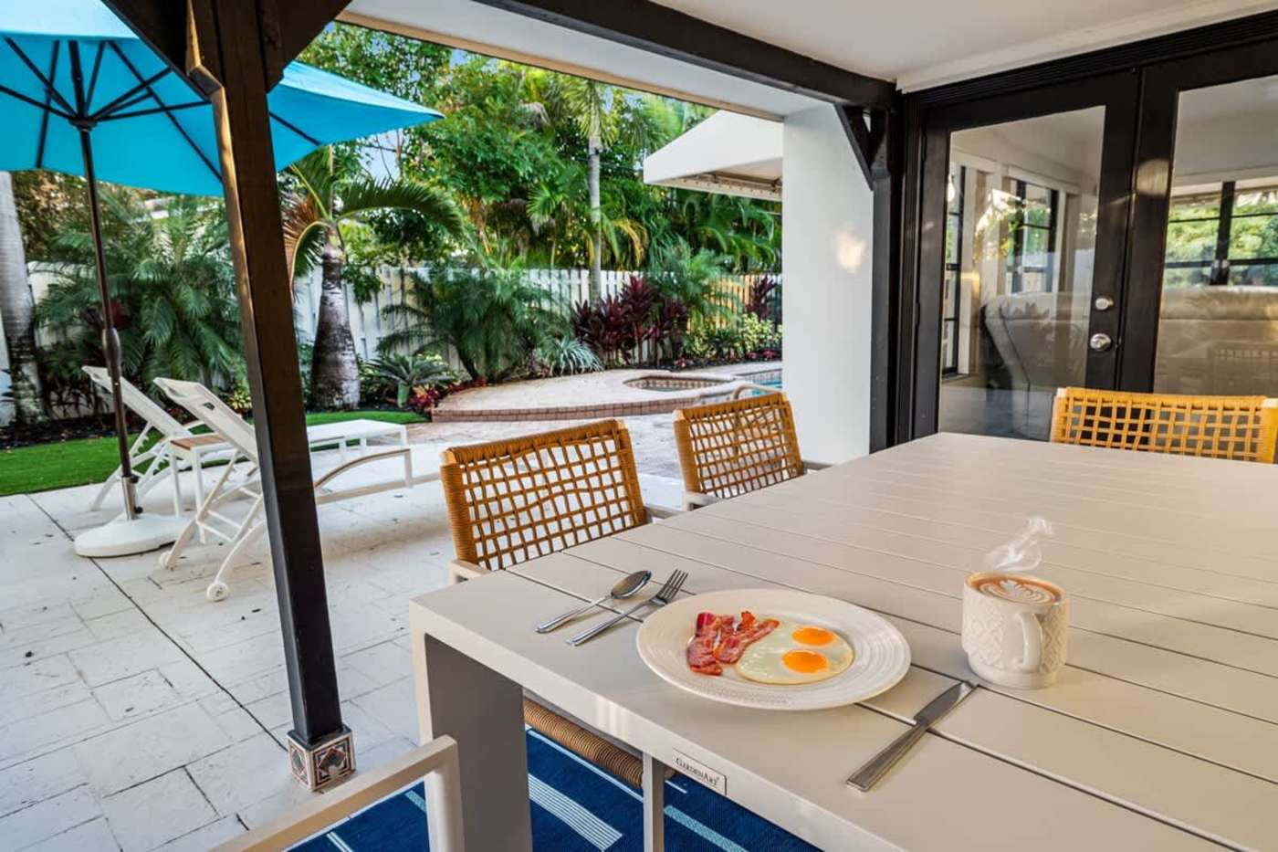 Gardens By The Sea: Outdoor dining under the parasol, looking across to the pool