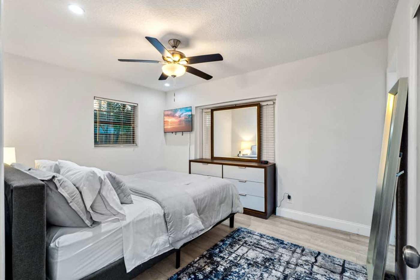 Gardens By The Sea: Bedroom with king bed, ceiling fan, dresser and mirror