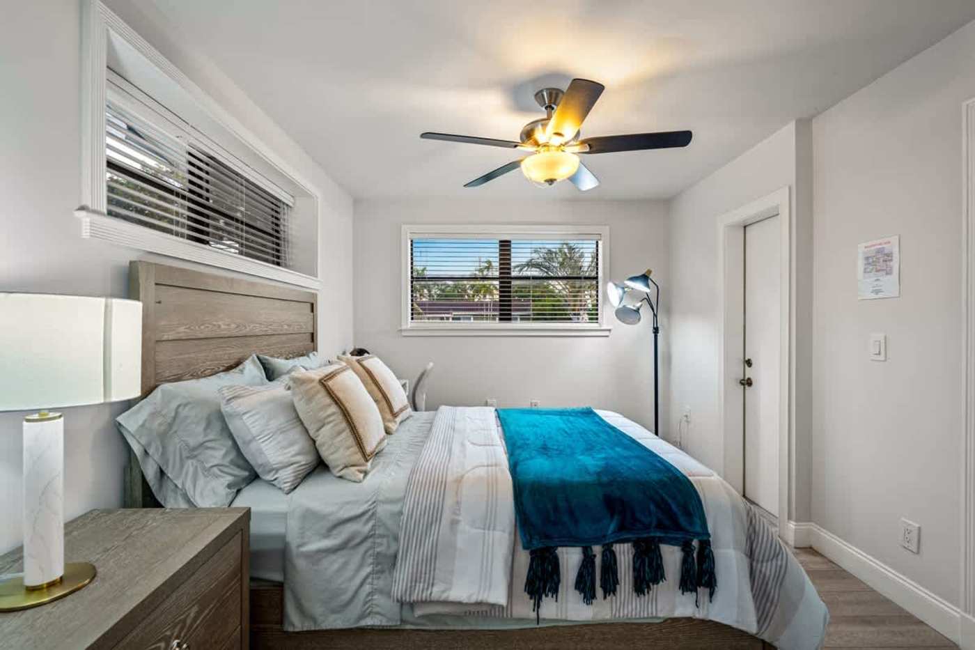 Gardens By The Sea: Bedroom with queen bed, ceiling fan and reading lamp