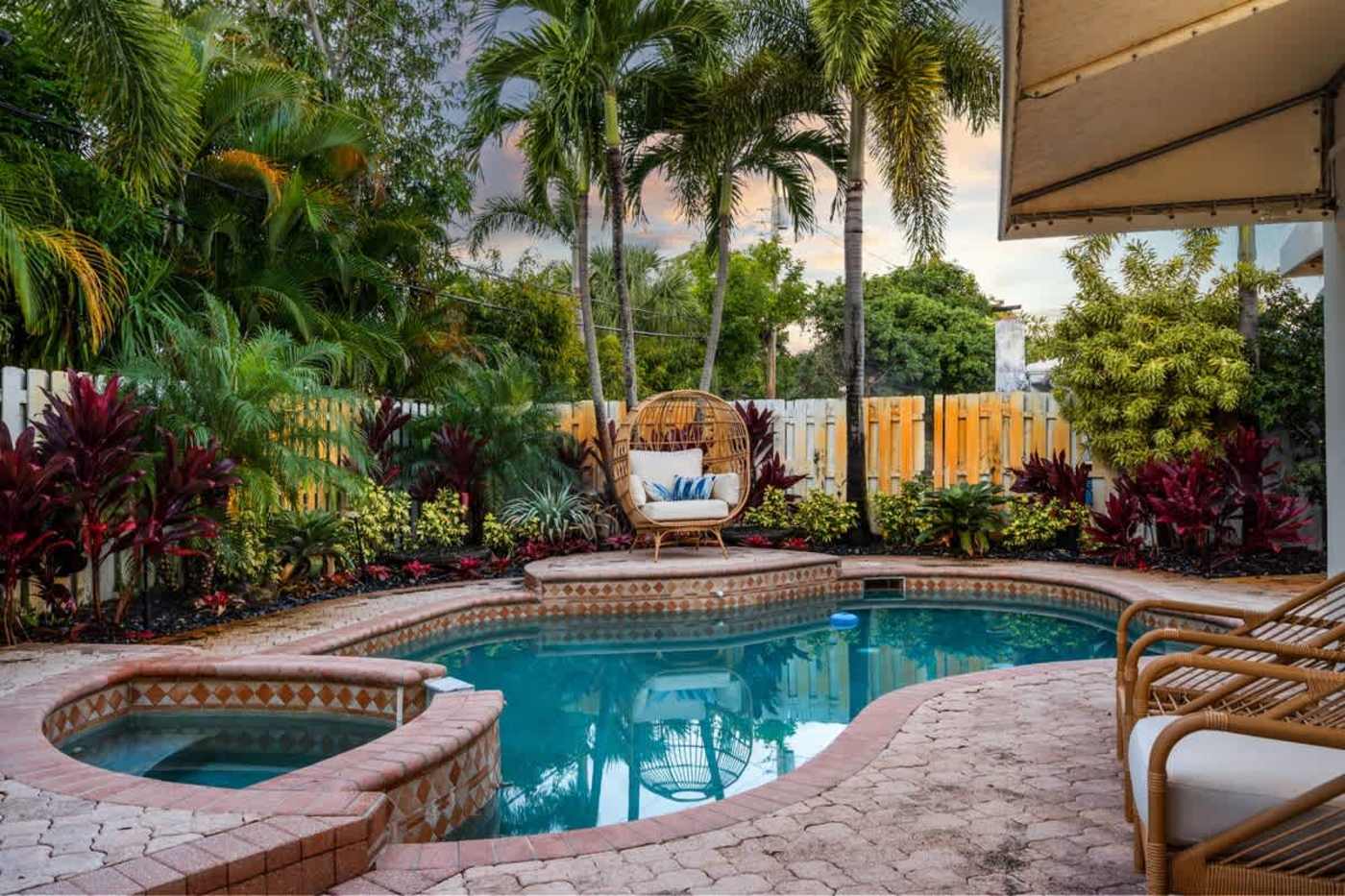 Gardens By The Sea: Pool, spa and hanging egg chair at sunset