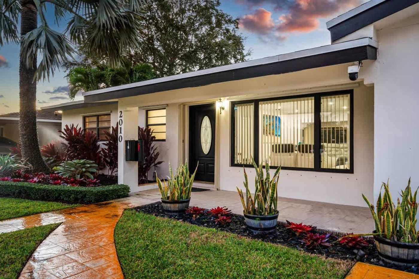 Gardens By The Sea: Front entrance with planting and a paved path to the door