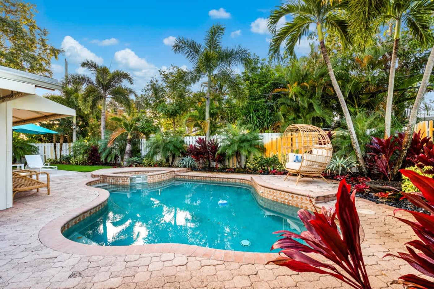 Gardens By The Sea: Pool and paver deck, with the egg chair and tropical planting