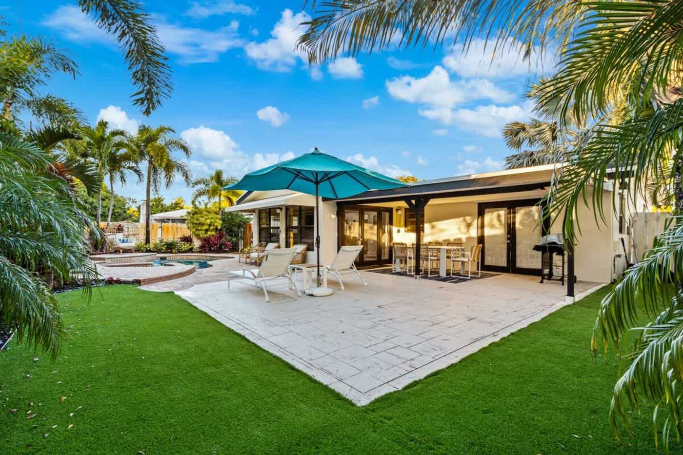 Gardens By The Sea: Lawn and covered patio, with dining and loungers on the deck