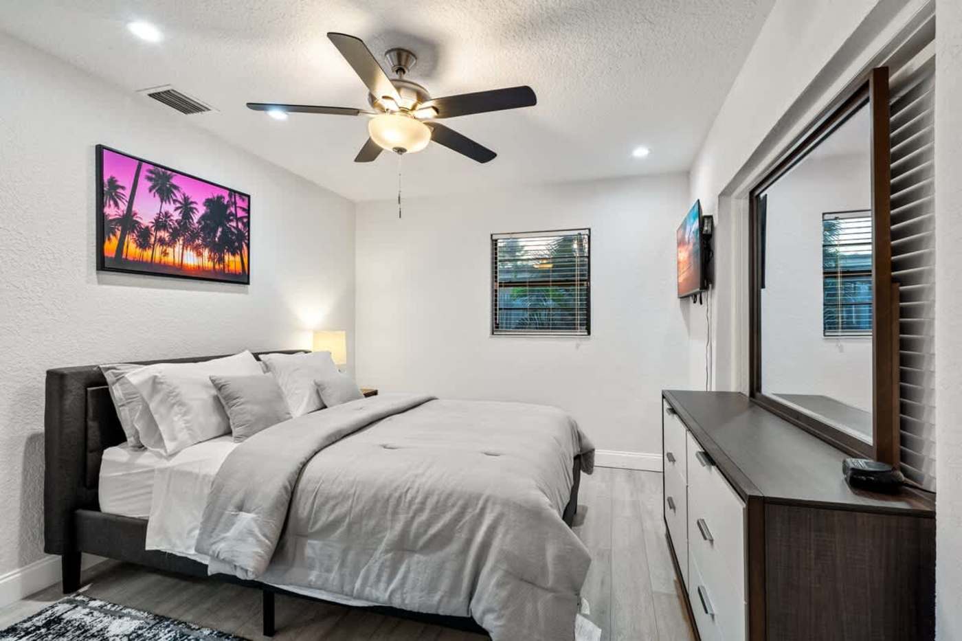 Gardens By The Sea: Bedroom with king bed, ceiling fan, smart TV and dresser