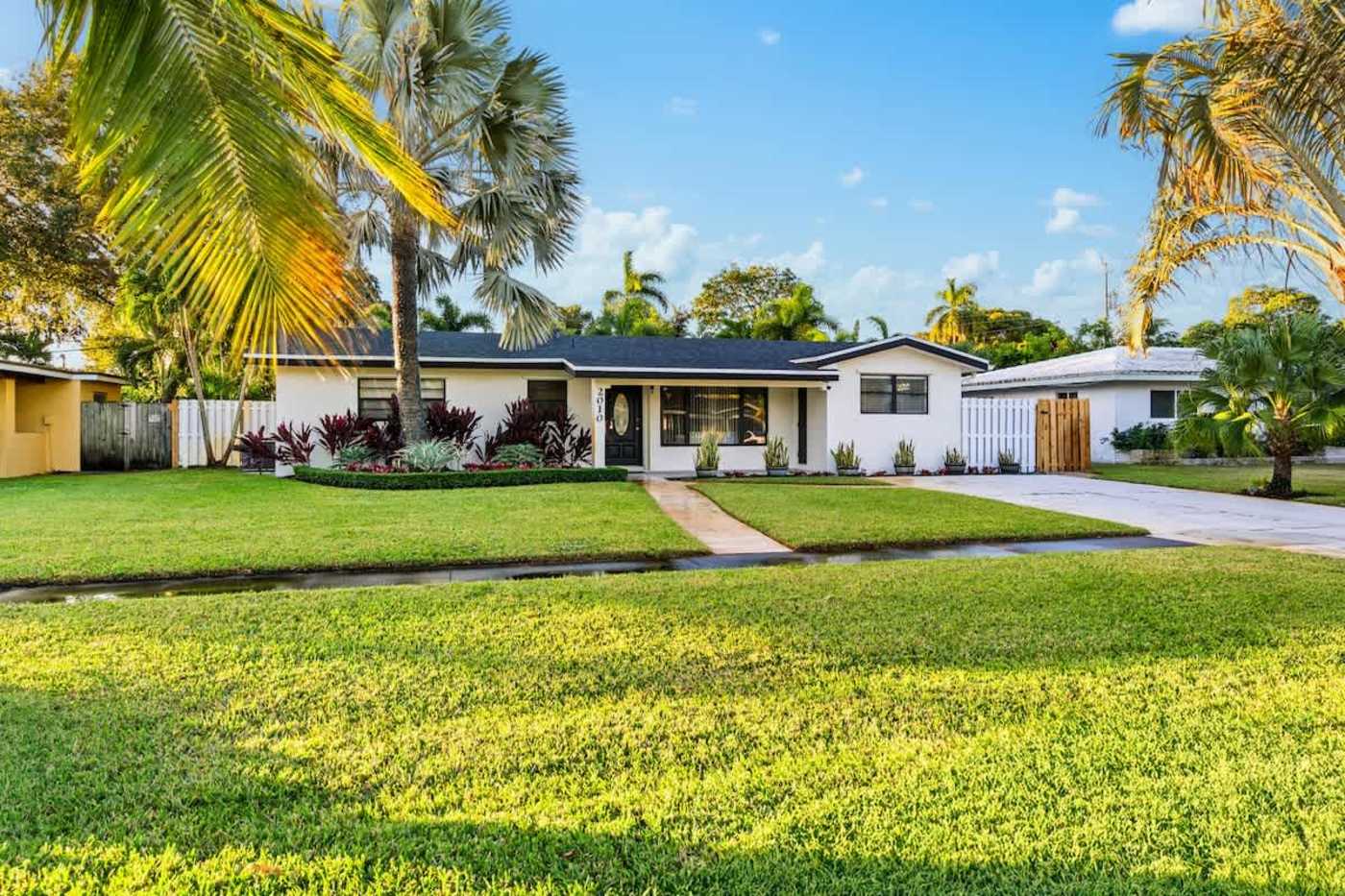 Gardens By The Sea: The house from the street, with the lawn and front path