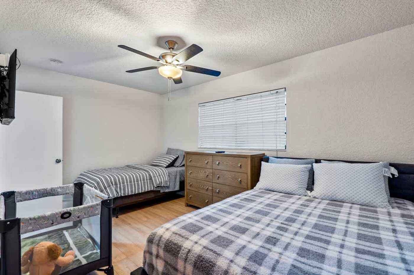 Gardens By The Sea: Bedroom with a king bed and two single beds, sleeping four