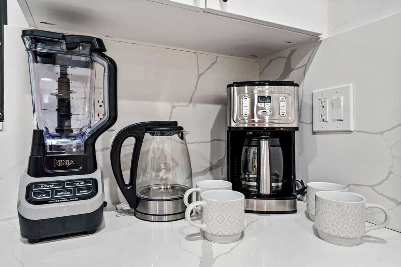 Gardens By The Sea: Blender, kettle and coffee maker on the kitchen counter