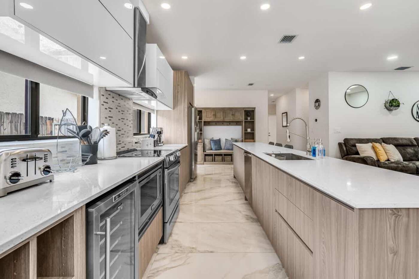 The Arcade House: Galley kitchen with wine fridge, oven and prep counter