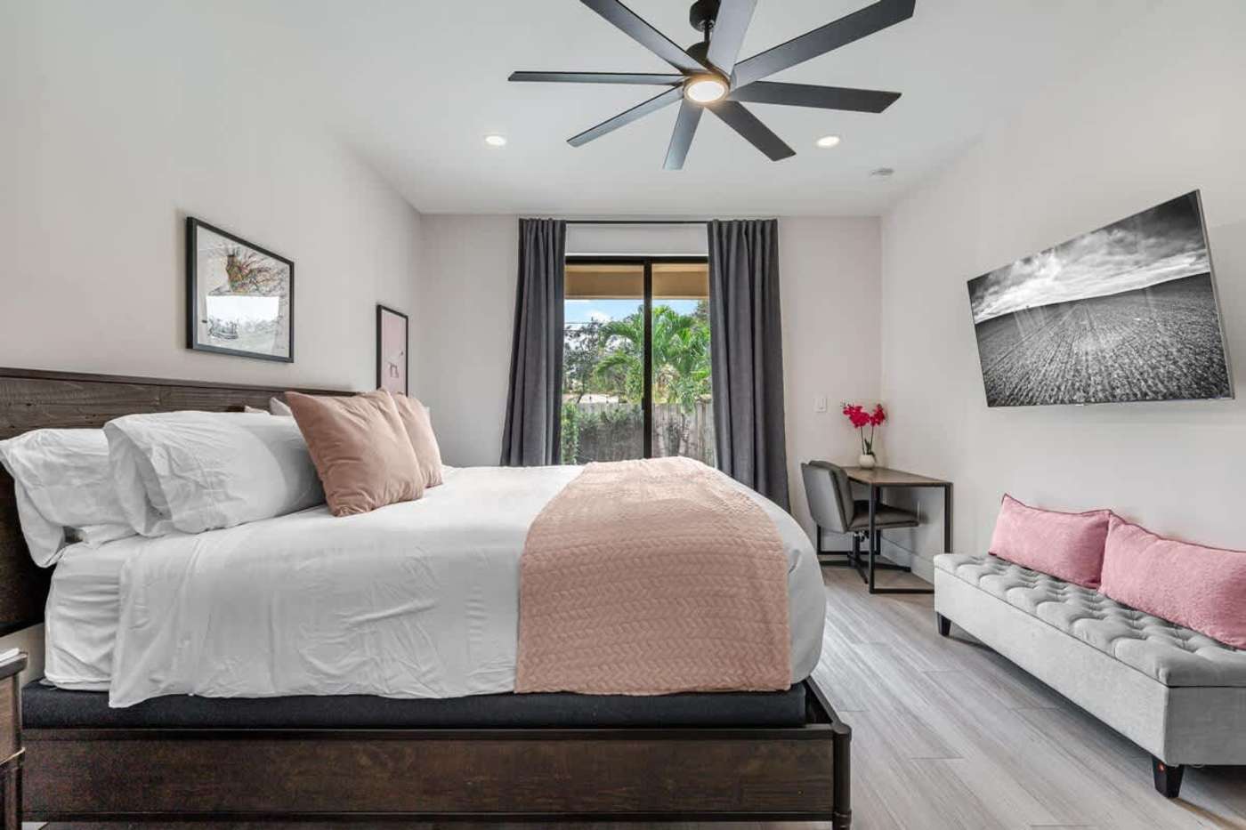 The Arcade House: Bedroom with king bed, smart TV and doors to the garden