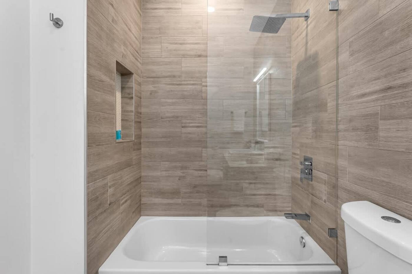 The Arcade House: Bathroom with bath, rain shower over and a tiled recess