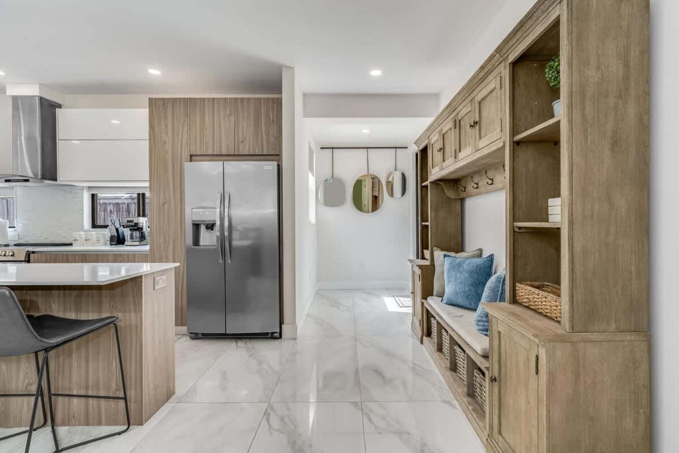 The Arcade House: Kitchen and hallway, with a built in bench and open shelving