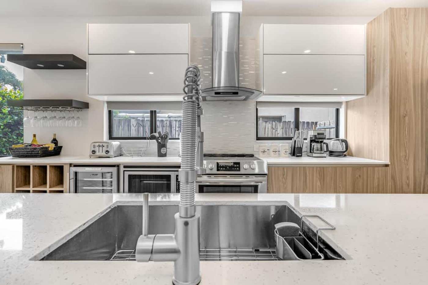The Arcade House: Kitchen sink and induction hob under the range hood