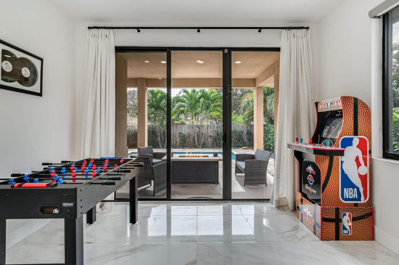 The Arcade House: Foosball table and NBA arcade machine by the patio doors