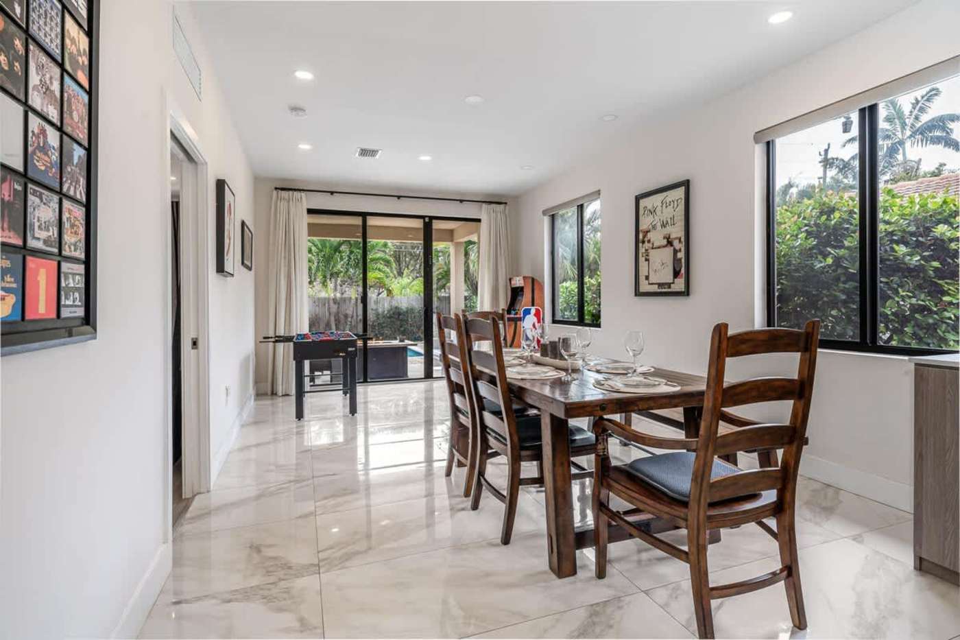 The Arcade House: Dining table for six, with the games area beyond